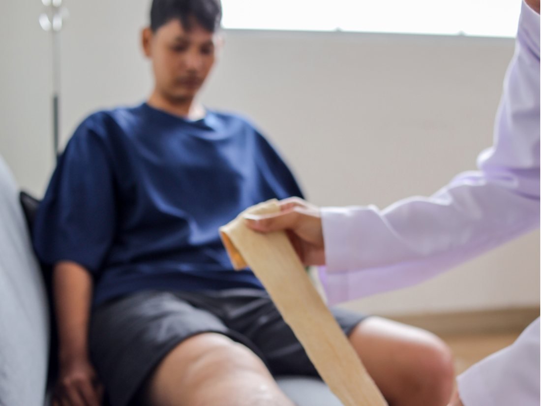 Clinician performing manual lymphatic drainage on a patient's leg