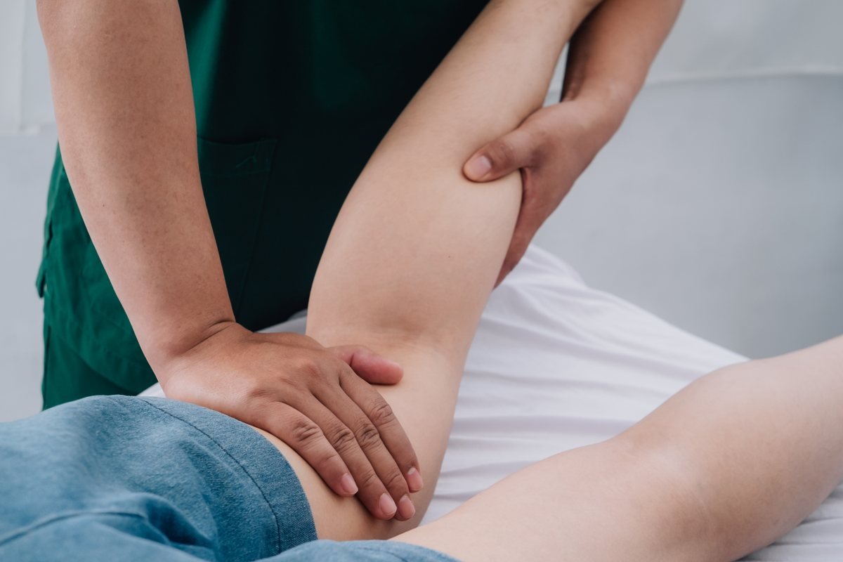 Manual lymphatic drainage being performed along a patient's back