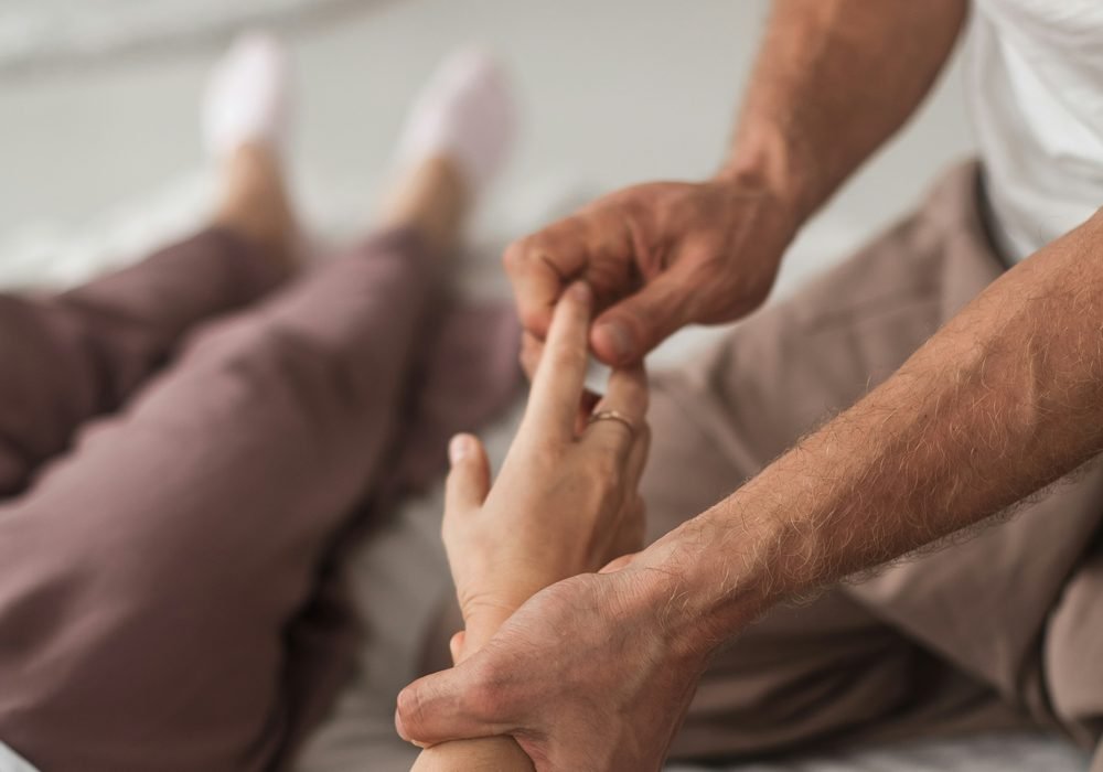 Close-up of a therapist's hands during treatment
