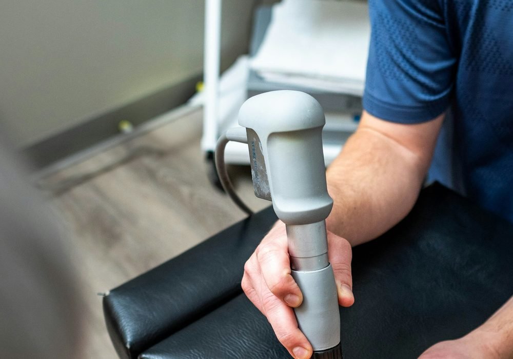 Therapist using an ultrasound device on a patient's arm