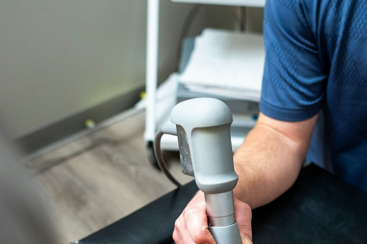 Physiotherapist performing a knee mobilisation on a patient in the clinic